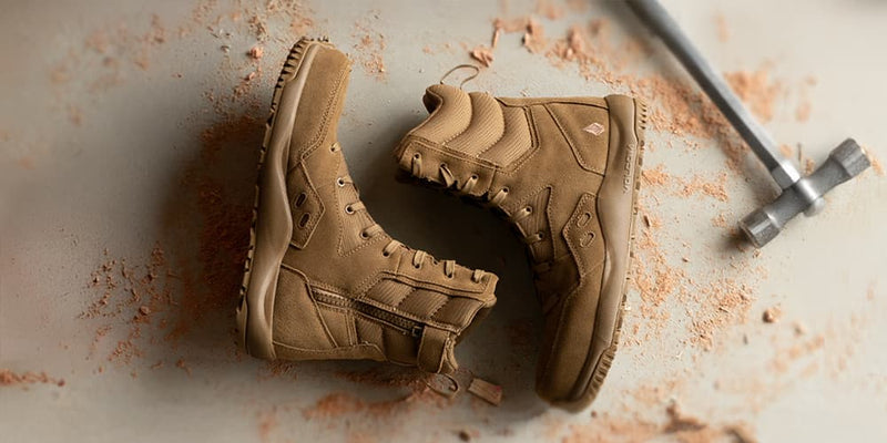 Tan tactical work boots with side zipper on a dusty floor—tactical work boots collection