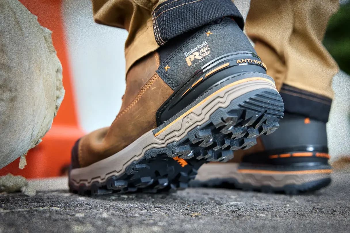 Worker wearing brown Timberland PRO work boots with Anti-Fatigue Technology at a construction site