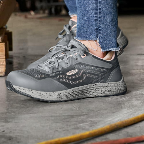 Close-up of women’s steel toe work shoe on jobsite floor