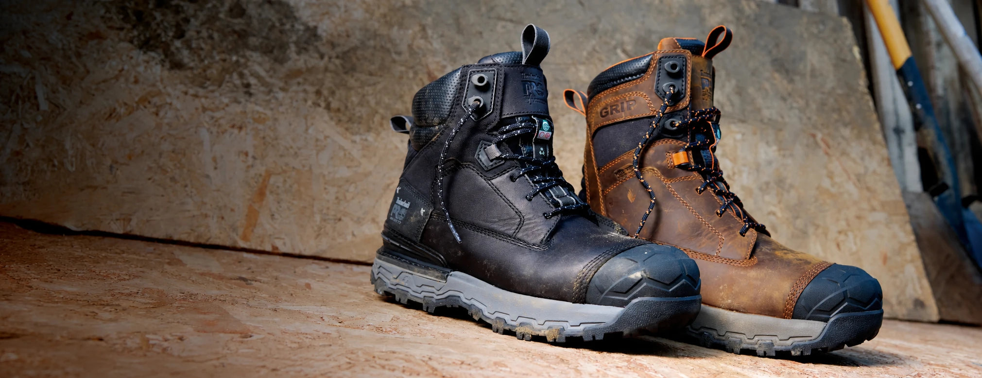 Black and brown Timberland PRO Boondock Ultralight work boots on an industrial workbench.