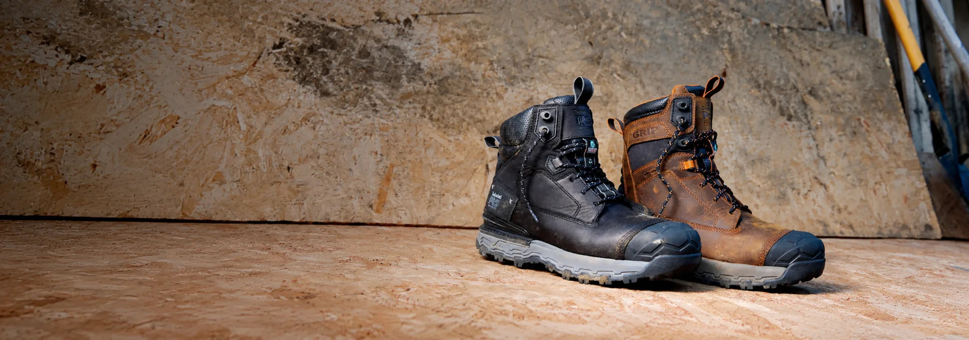 Black and brown Timberland PRO Boondock Ultralight work boots on an industrial workbench.